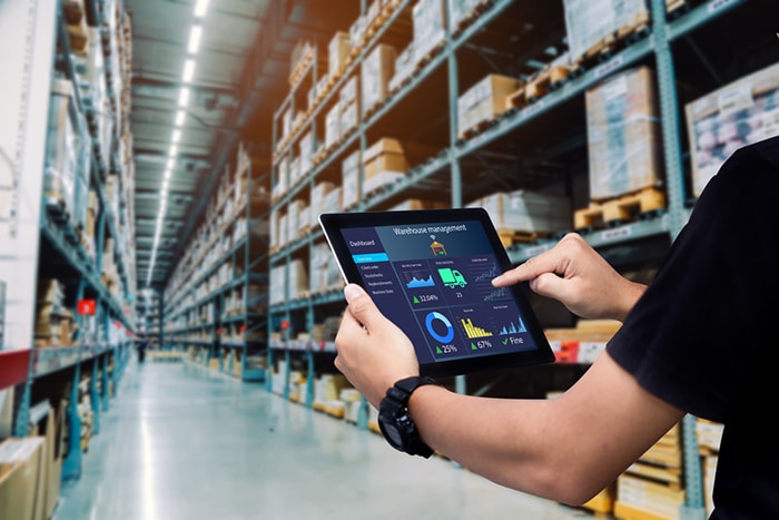 A warehouse manager tracks internal orders on a tablet