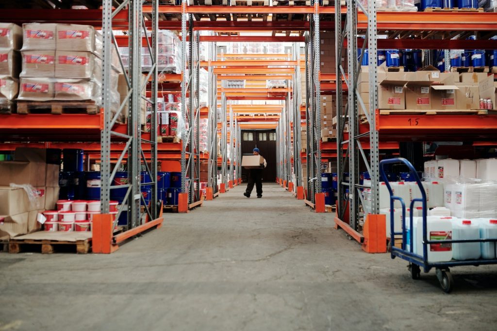 A warehouse employee carries a box