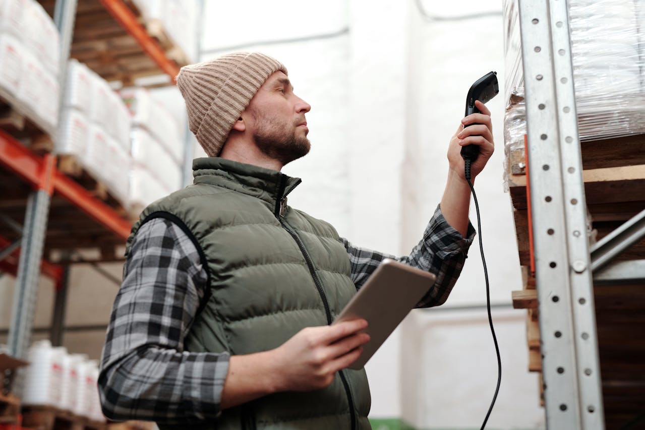 man scanning products in a warehouse